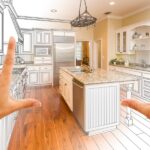 A point of view of someone standing in front of a half-finished, half-drawn kitchen with hands framing the space.
