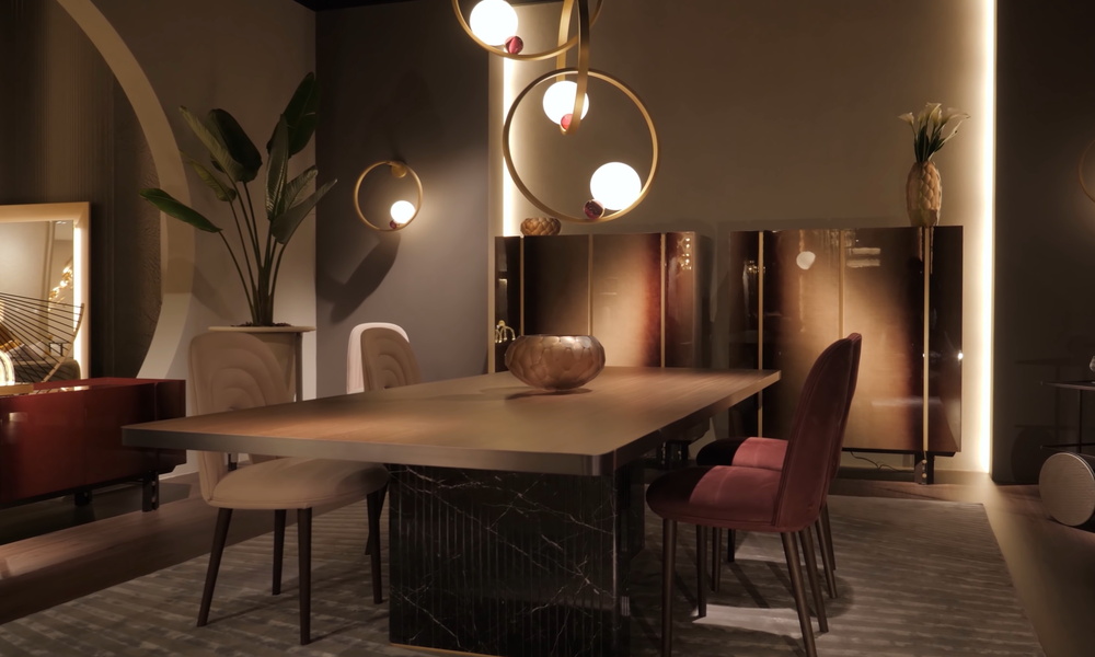 A dining room area with luxurious light fixtures. The lights are dimmed, and the space is decorated with gold accents.